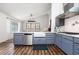 Stylish kitchen with stainless appliances, gray cabinets, and wood-look floors at 388 Rose Creek Pl, Woodstock, GA 30189