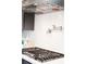 Modern stovetop with stainless steel hood and pot filler faucet at 388 Rose Creek Pl, Woodstock, GA 30189