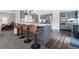 An open-concept kitchen boasts stainless steel appliances, sleek countertops, kitchen island, and breakfast bar seating at 388 Rose Creek Pl, Woodstock, GA 30189