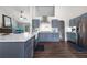 An open-concept kitchen boasts stainless steel appliances, sleek countertops, and gray cabinetry at 388 Rose Creek Pl, Woodstock, GA 30189