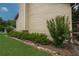 Landscaped yard with carefully trimmed hedges and accent lighting along the side of the house at 388 Rose Creek Pl, Woodstock, GA 30189