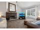 Living room featuring a stone fireplace, large mirror, and comfortable seating area at 388 Rose Creek Pl, Woodstock, GA 30189