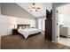 Vaulted ceiling bedroom boasts a private bath and board and batten accent wall at 388 Rose Creek Pl, Woodstock, GA 30189