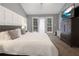 The large main bedroom features board and batten, private balcony, and neutral decor at 388 Rose Creek Pl, Woodstock, GA 30189
