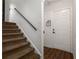 Carpeted staircase with a dark handrail and white walls leading to a landing at 388 Rose Creek Pl, Woodstock, GA 30189