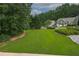 Spacious yard showcases mature trees and beautiful landscaping, offering privacy and a serene atmosphere at 388 Rose Creek Pl, Woodstock, GA 30189