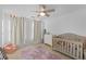 Bright Bedroom featuring a crib, plush chair, and princess themed area rug at 109 Hale View Cir, Canton, GA 30114