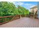 Wooden deck with railing surrounded by lush trees offering a private outdoor space for relaxation and entertaining at 109 Hale View Cir, Canton, GA 30114