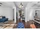 Open foyer with hardwood floors, decorative rug, view into living room with a stone fireplace and access to the dining room at 109 Hale View Cir, Canton, GA 30114