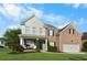 Charming two-story brick home with blue shutters, a covered porch, and a well-manicured front lawn at 109 Hale View Cir, Canton, GA 30114