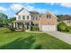 Charming two-story brick home featuring a manicured lawn, attached garage, and inviting front porch with stylish blue shutters at 109 Hale View Cir, Canton, GA 30114