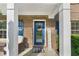 Inviting front porch with seating, brick accents, and a charming blue front door, adorned with a 'Welcome' wreath at 109 Hale View Cir, Canton, GA 30114
