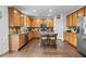 Spacious kitchen featuring wooden cabinets, stainless appliances, granite counters, and an island with seating at 109 Hale View Cir, Canton, GA 30114
