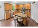 Spacious kitchen featuring wooden cabinets, stainless appliances, granite counters, and an island with seating at 109 Hale View Cir, Canton, GA 30114