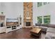 Bright living room with a stone fireplace, hardwood floors, and large windows for natural light at 109 Hale View Cir, Canton, GA 30114