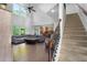 Spacious living area with a staircase and views of the kitchen and deck providing an inviting area for relaxation and entertainment at 109 Hale View Cir, Canton, GA 30114