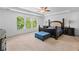 Large main bedroom featuring plush carpet, tray ceilings, and a bay window at 109 Hale View Cir, Canton, GA 30114