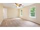 Bright bedroom features neutral paint, plush carpeting, and sun-filled windows at 3255 Marine Rd, Cumming, GA 30041