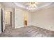 Large bedroom featuring a tray ceiling and access to an en-suite bathroom at 3255 Marine Rd, Cumming, GA 30041