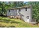 Back exterior view of a house with vinyl siding and walk-out basement at 3255 Marine Rd, Cumming, GA 30041