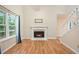 Bright living room boasts hardwood floors, a fireplace, and large windows offering natural light at 3255 Marine Rd, Cumming, GA 30041