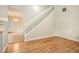 Bright living room with hardwood floors, a staircase, and access to adjacent dining and kitchen at 3255 Marine Rd, Cumming, GA 30041