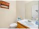 Traditional powder room with oak vanity and wall storage at 3255 Marine Rd, Cumming, GA 30041