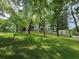 View of community building from a grassy, tree covered lawn at 525 Parkway Ne Dr # 306, Atlanta, GA 30308