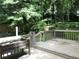 Back deck showing its railing and steps with a view of the lush green backyard at 5820 Elm Tree Dr, Buford, GA 30518