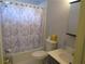 Cozy bathroom features a tub with shower and modern fixtures at 5820 Elm Tree Dr, Buford, GA 30518