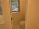 This bathroom has a white toilet and window at 5820 Elm Tree Dr, Buford, GA 30518