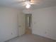 Clean, neutral bedroom with an open doorway to an adjacent room, offering versatile space at 5820 Elm Tree Dr, Buford, GA 30518