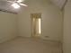 Carpeted bedroom with vaulted ceiling and view to en-suite bathroom at 5820 Elm Tree Dr, Buford, GA 30518
