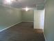 Large bedroom with neutral carpeting, ceiling fan, and a light green color scheme at 5820 Elm Tree Dr, Buford, GA 30518