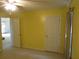Bedroom with two doors, neutral carpet, and a sunlit window, offering privacy and functionality at 5820 Elm Tree Dr, Buford, GA 30518