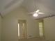 Open bedroom featuring vaulted ceiling and ceiling fan at 5820 Elm Tree Dr, Buford, GA 30518