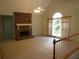 Spacious living room featuring a stone fireplace, vaulted ceilings, and large windows offering ample natural light at 5820 Elm Tree Dr, Buford, GA 30518