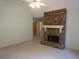 Cozy living room featuring a stone fireplace, neutral paint, and carpet flooring with an adjoining hallway at 5820 Elm Tree Dr, Buford, GA 30518