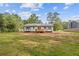 View of home's rear, showcasing a small wooden deck and back yard at 2310 Whitehead Place Dr, Suwanee, GA 30024