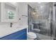 Modern bathroom featuring a dark vanity and a frameless glass shower at 2310 Whitehead Place Dr, Suwanee, GA 30024