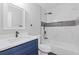 Modern bathroom featuring a blue vanity, updated fixtures, and a tiled shower/tub combo at 2310 Whitehead Place Dr, Suwanee, GA 30024