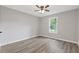 Spacious bedroom with wood floors and a window providing natural light at 2310 Whitehead Place Dr, Suwanee, GA 30024