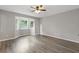 Large bedroom with wood floors and a bay window providing natural light at 2310 Whitehead Place Dr, Suwanee, GA 30024