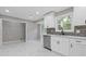 Bright kitchen featuring white cabinets, stainless steel appliances, tile backsplash, and marble flooring at 2310 Whitehead Place Dr, Suwanee, GA 30024