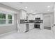 Bright kitchen features modern cabinets, stainless appliances, a stylish backsplash, and marble floors at 2310 Whitehead Place Dr, Suwanee, GA 30024