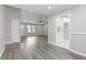 Spacious living room boasts new floors, modern fan, and is adjacent to kitchen at 2310 Whitehead Place Dr, Suwanee, GA 30024