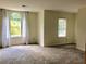 Spacious bedroom featuring plush carpeting, two bright windows with decorative curtains, and neutral walls at 1271 Whitlock Ridge Sw Dr, Marietta, GA 30064
