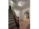 Inviting entryway with carpeted stairs, wood floors, and decorative lighting at 1271 Whitlock Ridge Sw Dr, Marietta, GA 30064