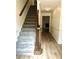 Welcoming entryway featuring carpeted stairs, hardwood floors, and access to the living room at 1271 Whitlock Ridge Sw Dr, Marietta, GA 30064