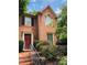 Charming brick home with black shutters, red front door, and meticulously maintained landscaping at 1271 Whitlock Ridge Sw Dr, Marietta, GA 30064